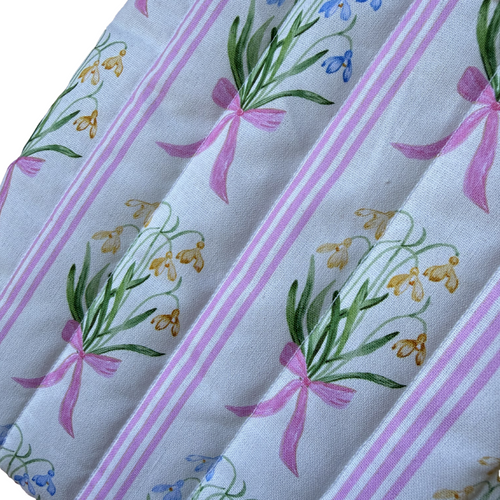 Fabric with floral and ribbon pattern and 'by florence' label.
